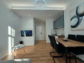 Standard Apartment | Living area | 40-inch Smart TV with cable channels