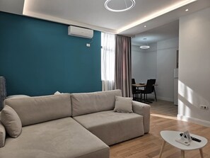 Standard Apartment | Living area | 40-inch Smart TV with cable channels