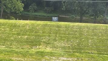 A grassy area with a sign for "Slivak's Private Dock."