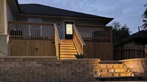 A house with a swimming pool, wooden deck, and stone wall. - Family Getaway ~Renovated 3BR Home+ Private Pool Close to Airport, DT, & F1 (Austin)