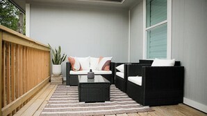 A patio area with a sofa set, a coffee table, and a potted plant. - Family Getaway ~Renovated 3BR Home+ Private Pool Close to Airport, DT, & F1 (Austin)