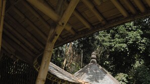 A traditional bamboo structure with a circular window and a thatched roof. - The Kul Kul Farm (Abiansemal)