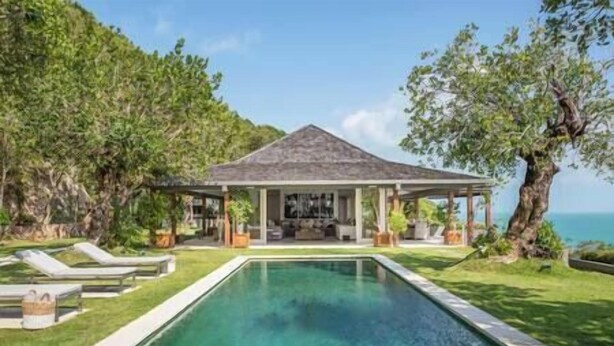 A pool with a covered seating area and lounge chairs. - Element of 8 at Cape Laem Sor Estate by Elite Havens (Surat Thani)
