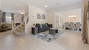 A spacious living area with a staircase, a dining area, and a kitchen. - Two Kings, Heated Pool, Whirlpool Jet Bathtub &BBQ (Flower Mound)