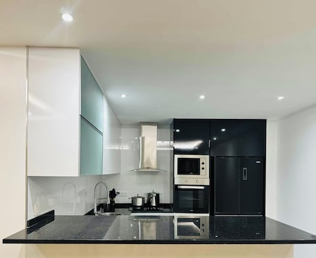 Private kitchen. Adorable 3-bedroom apartment in Praia for a relaxing getaway