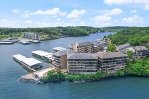A waterfront hotel with multiple buildings, docks, and a river.