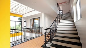 A modern interior with a staircase, wooden flooring, and a balcony with a railing. - Hometown An Vien Villa Hoi An (Hoi An)