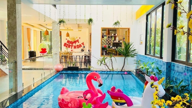 An indoor swimming pool with inflatable toys and a 'Happy Birthday' sign. - Hometown An Vien Villa Hoi An (Hoi An)