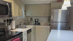 A compact kitchen with a microwave, stove, oven, and refrigerator. It includes wooden cabinets, a sink, and a countertop. - Mount Gretna Magic ▪︎ 10 mins to Renaissance Faire  (Mount Gretna)