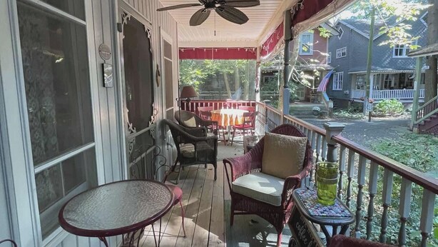 A covered porch with wicker furniture, a table, and chairs. - Mount Gretna Magic ▪︎ 10 mins to Renaissance Faire  (Mount Gretna)