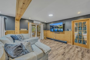 Smart TV, fireplace, books, computer monitors