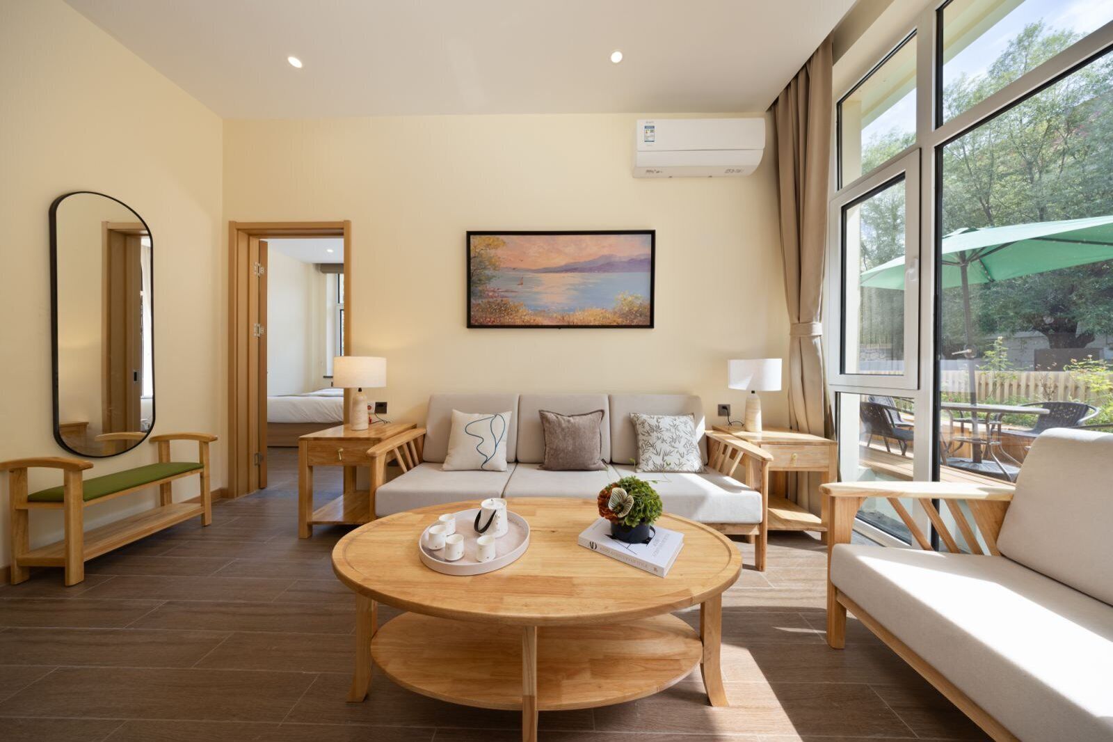 A modern living room with a sofa, coffee table, and a painting on the wall.