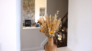 A staircase with a vase of dried flowers on a table. - 3-bedroom Holiday Home With Panoramic View (Gesves)