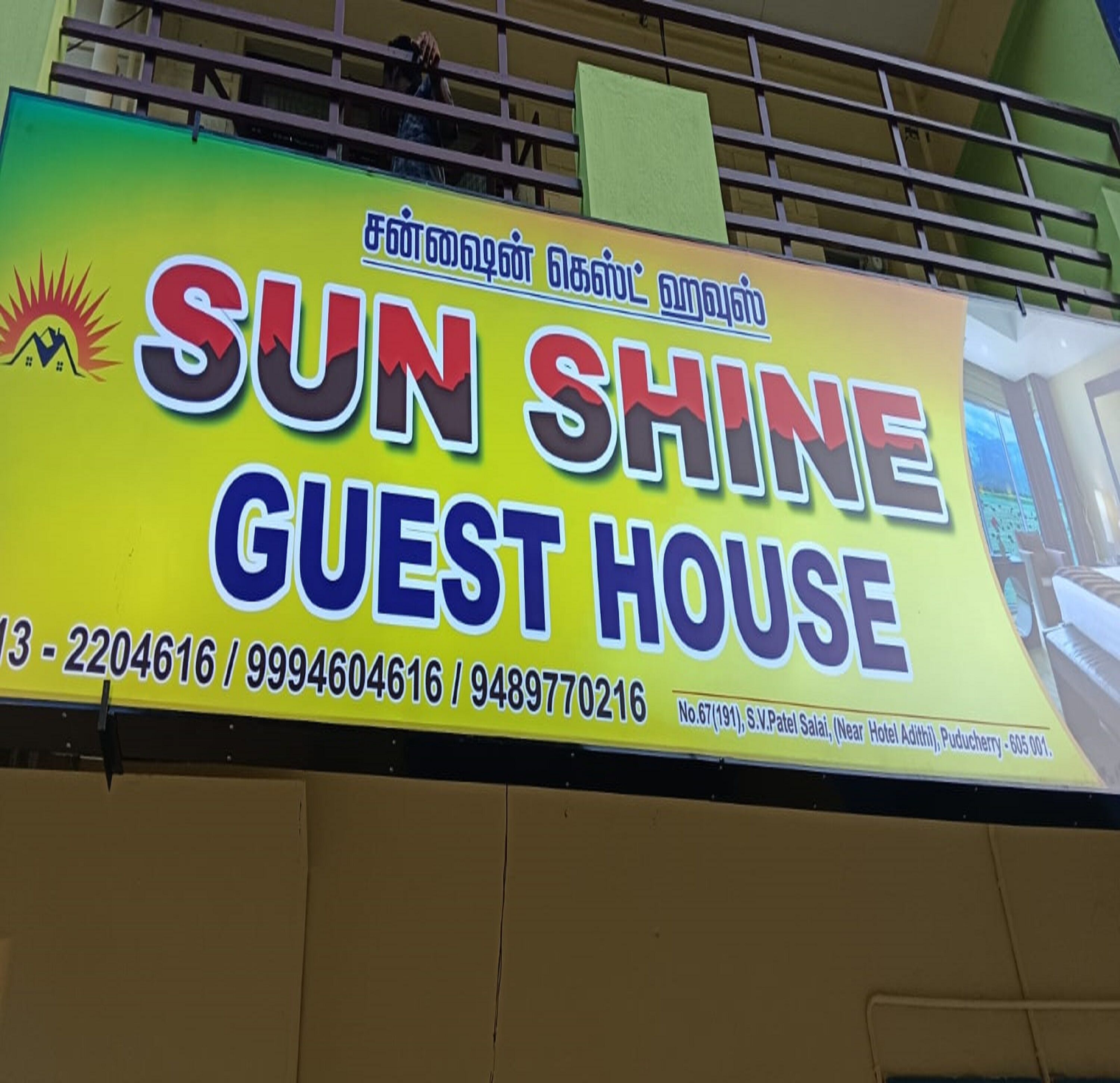 Skilt for 'Sun Shine Guest House' med kontaktoplysninger og adresse.
