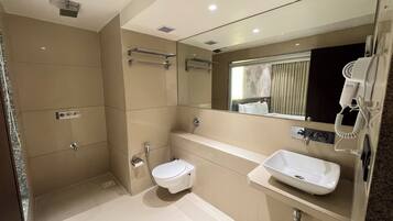 A modern bathroom with a bathtub, a toilet, and a sink.