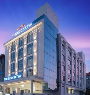 Un edificio moderno di un hotel con un cartello che riporta la scritta "HOTEL THE ECO SATVA".