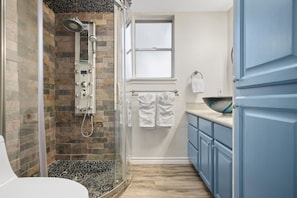 Shower, hair dryer, towels, shampoo