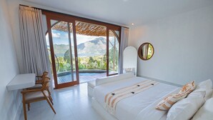 A bedroom with a bed, a desk, and a chair. There is a large window with a view of mountains and a pool. - Pulestis Glamping (Kintamani)