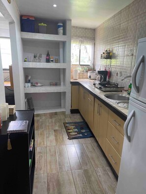 Fridge, microwave, stovetop, coffee/tea maker