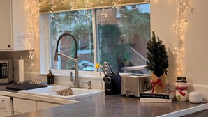 A kitchen with a modern faucet, a toaster, and a small Christmas tree. - Forest Escape – Hiking & Rattlesnake Lake Nearby (North Bend)