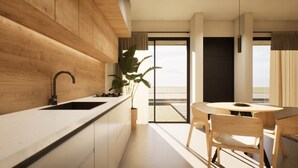A modern kitchen with a wooden countertop, a sink, and a dining area with a table and chairs. - Luxurious Tanki Flip Townhouses with Rooftop & Pool Palm Beach Area (Noord)
