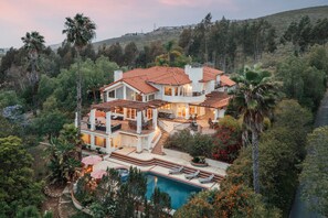 A large house with multiple levels, a swimming pool, and a landscaped garden. - Private Pool, Hot Tub & Valley Views Near Wineries | The Ranch by AvantStay (Escondido)