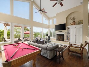 A spacious living area with a pool table, comfortable seating, a fireplace, and a television. - Private Pool, Hot Tub & Valley Views Near Wineries | The Ranch by AvantStay (Escondido)