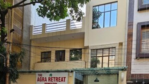 Un edificio con un letrero que dice "The Agra Retreat Homestay", indicando que es un hogar lejos del hogar.
