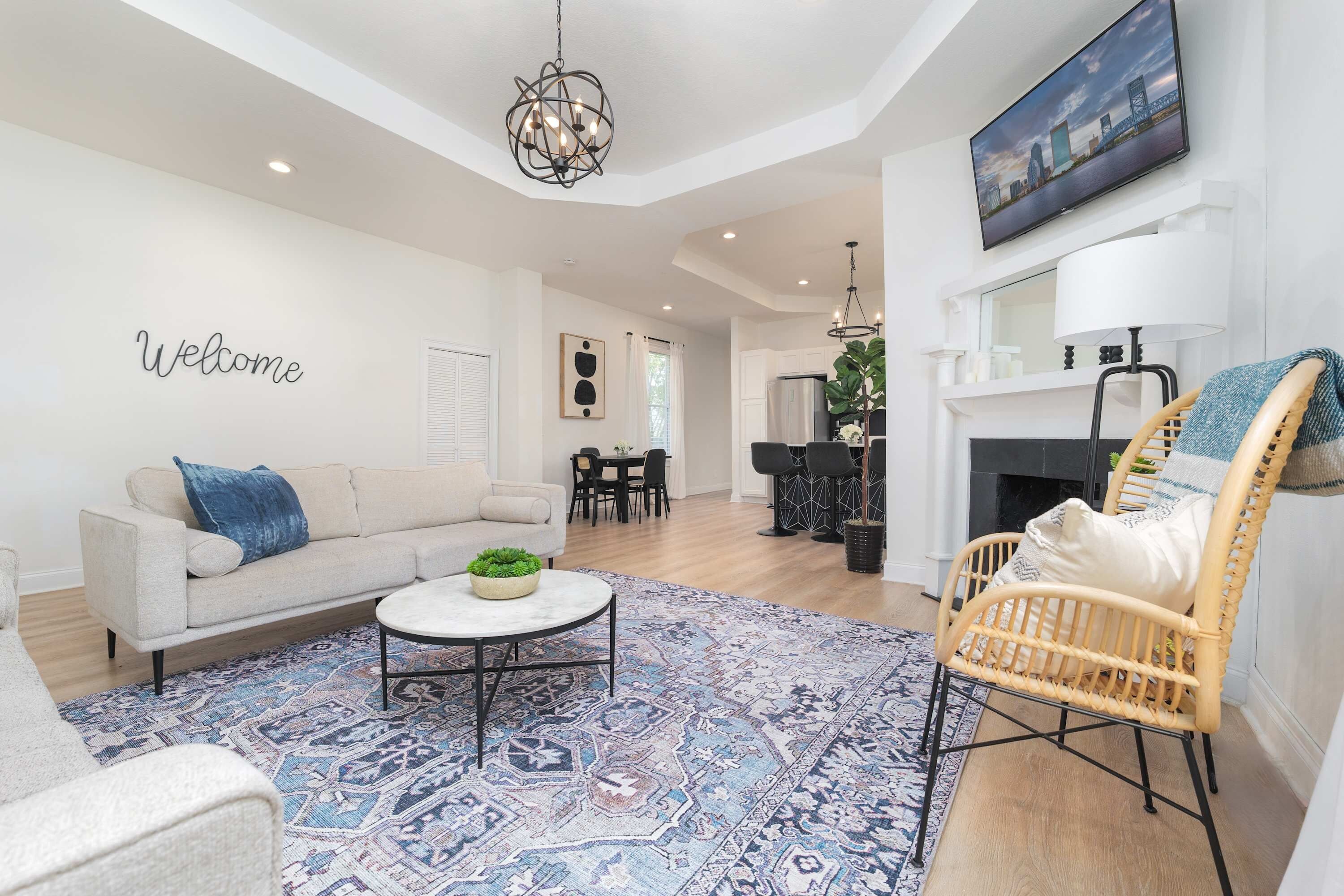 A modern living room with a sofa, coffee table, and a decorative rug.