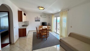 A compact living space with a kitchenette, dining area, and a sofa. - Apartment Velvet Vista 5 (Novi Vinodolski)