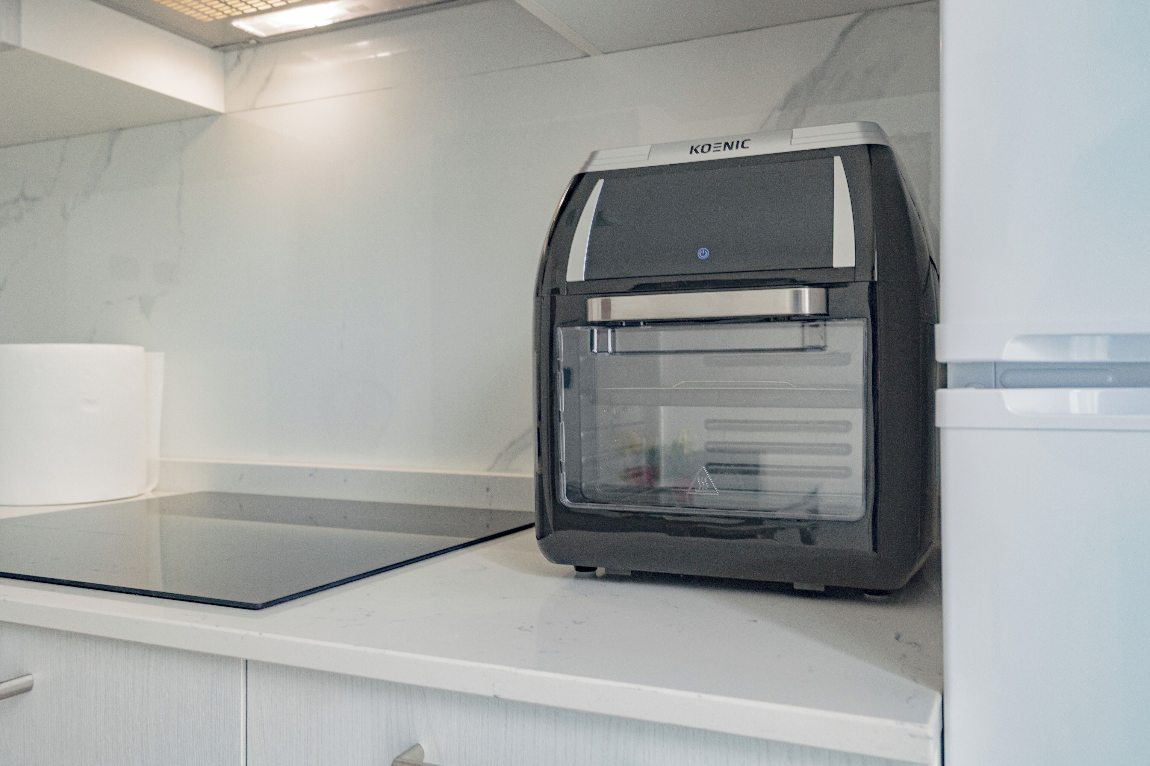 A modern kitchen with a built-in oven and microwave.