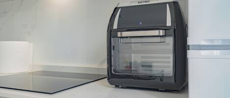 A modern kitchen with a built-in oven and microwave.