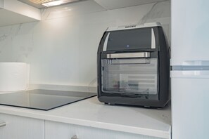 A modern kitchen with a built-in oven and microwave. - Fior di Loto (A9) | Large Studio | Rho Fiera | Malpensa | Milan (Cesate)