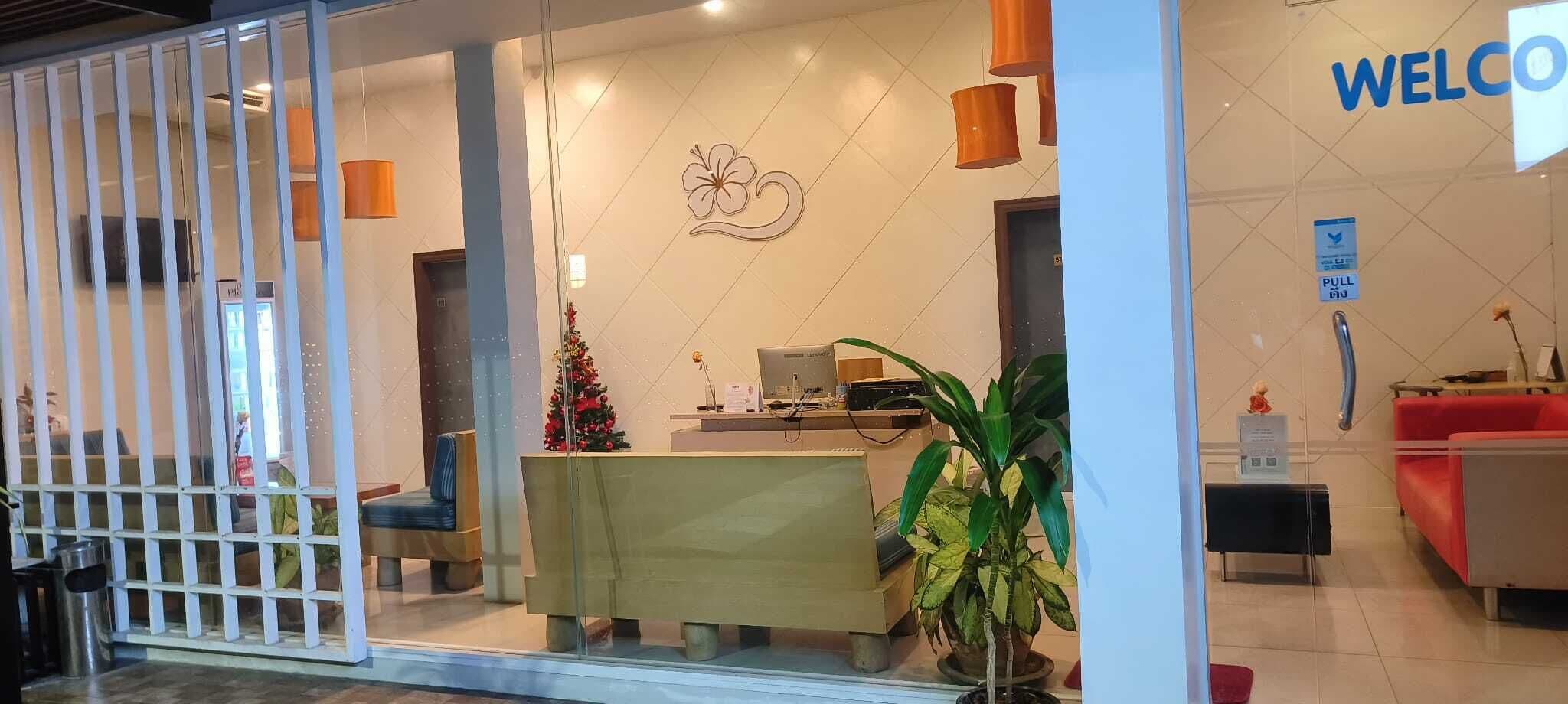 A reception area with a desk, a Christmas tree, and a 'WELCOME' sign.