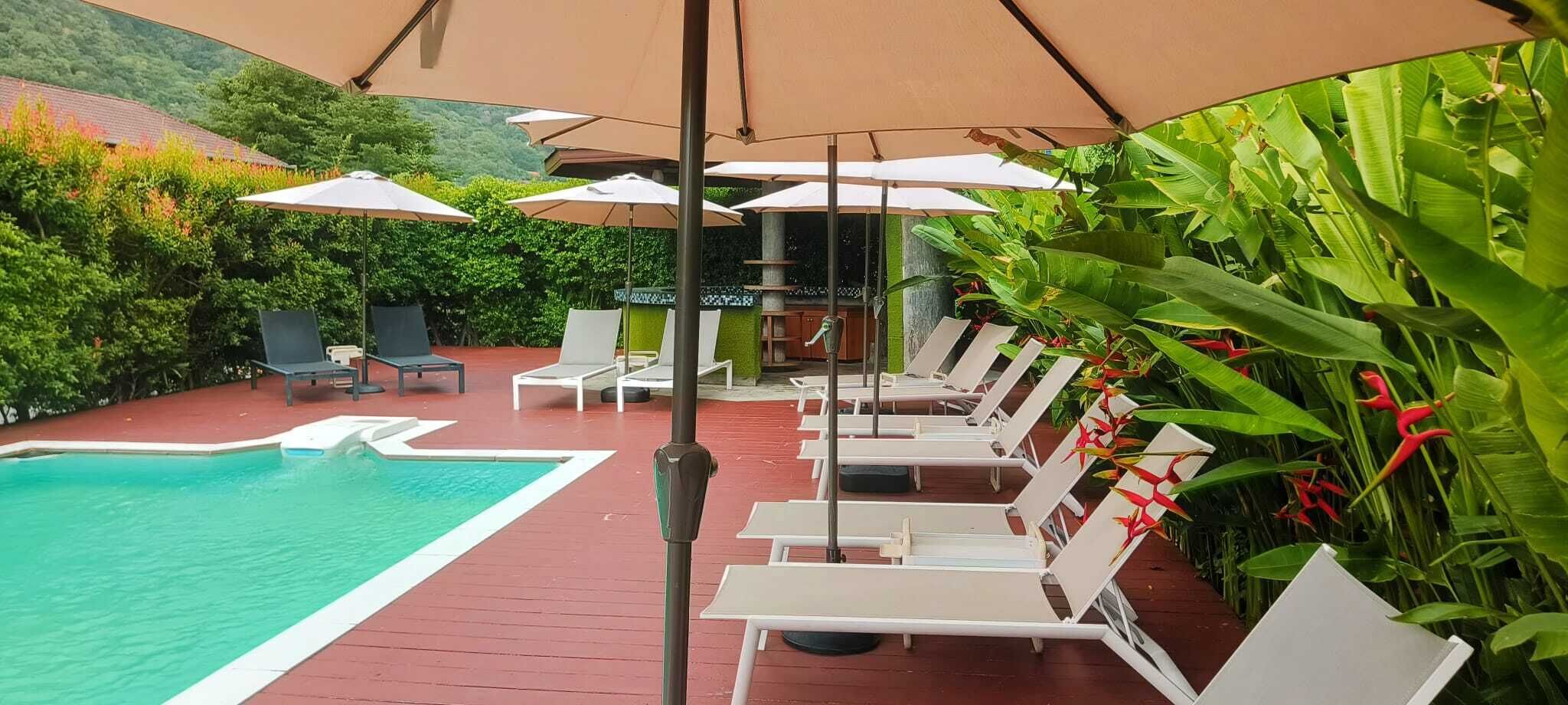 Outdoor pool, open 8:00 AM to 6:00 PM, pool umbrellas