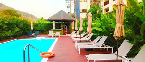Outdoor pool, open 8:00 AM to 6:00 PM, pool umbrellas