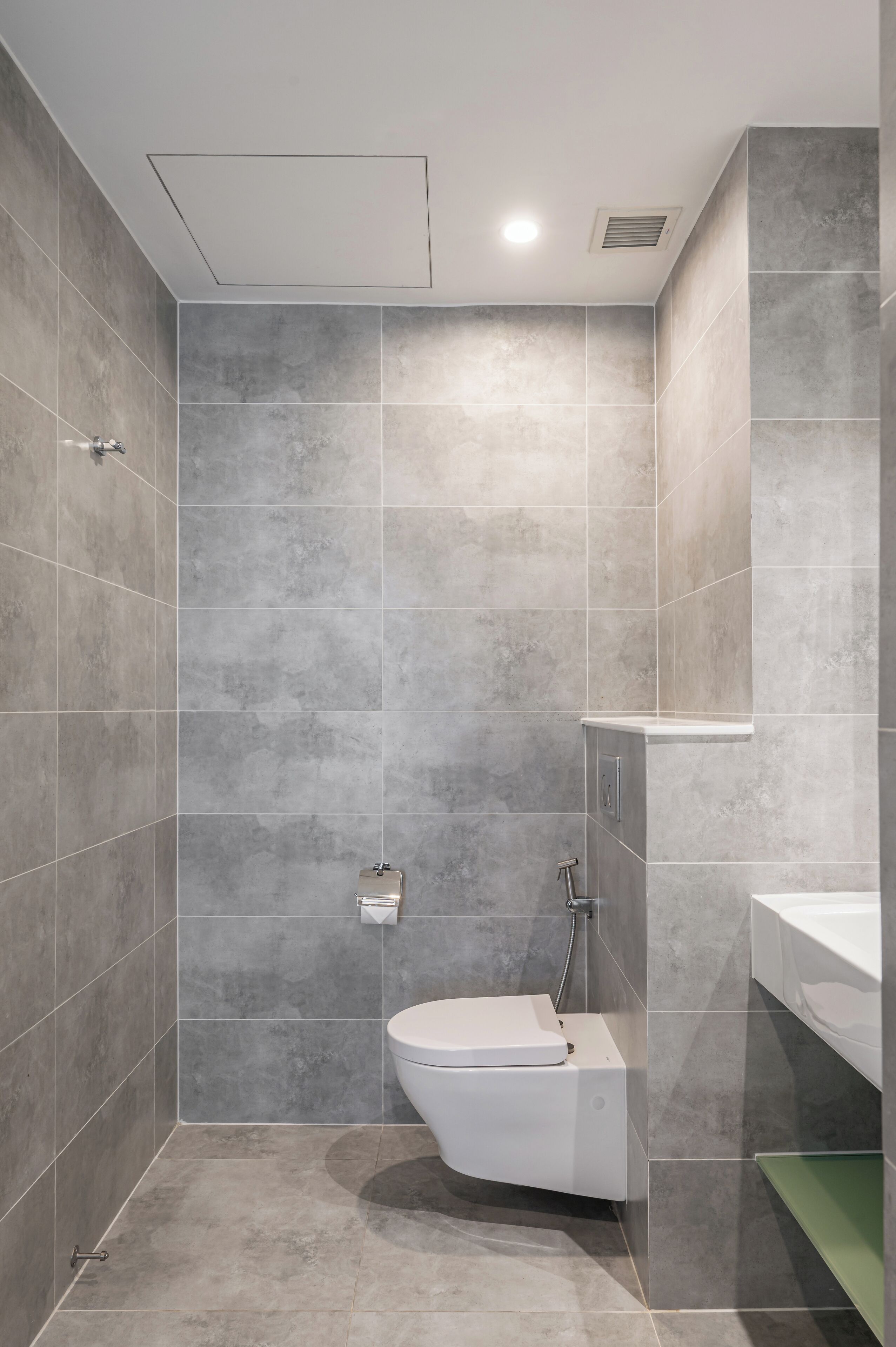 Un baño moderno con inodoro, ducha y lavabo.