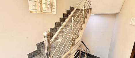 A staircase with metal railings and granite steps.