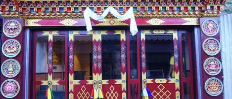 A building with a colorful facade, featuring intricate patterns and designs on the walls and doors.