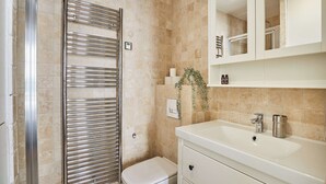 A bathroom with a white sink, a mirror, and a toilet. - Superb Studio Center of Paris Montorgueil (Paris)