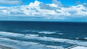 A coastal view with a beach and ocean. - Coastal Waves Ocean View Studio condo (Daytona Beach)
