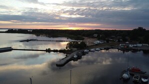 A marina with boats docked, a pier, and buildings in the background. - Holiday Home in Stepnica Near Szczecin Lagoon (Stepnica)