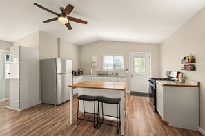 Fridge, microwave, cookware/dishes/utensils, dining tables