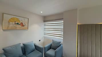 Luxury Suite, City View | Desk, laptop workspace, blackout curtains, iron/ironing board