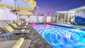 A poolside area with lounge chairs, a flamingo float, and a mural.