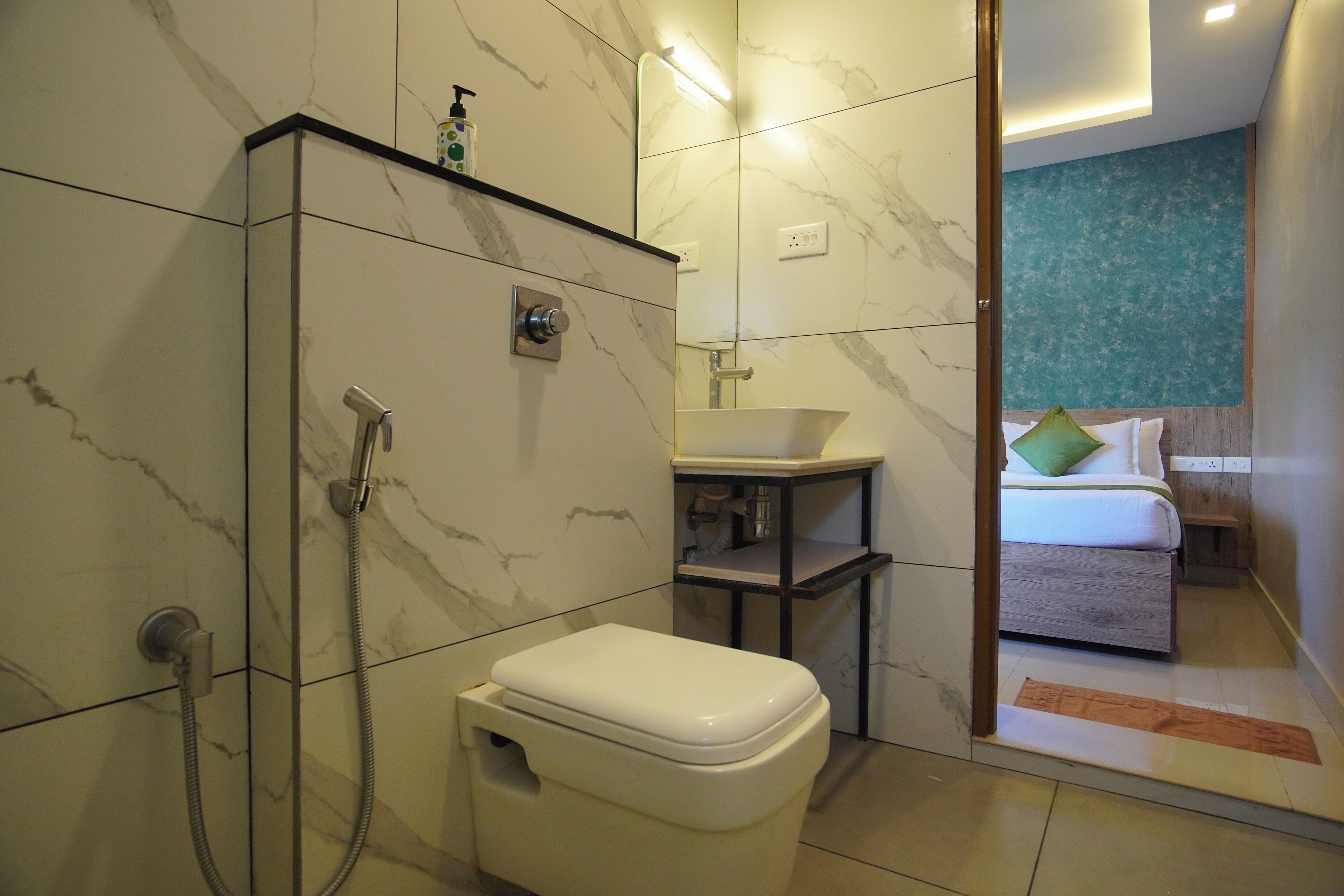 A modern bathroom with a toilet, shower, and sink.
