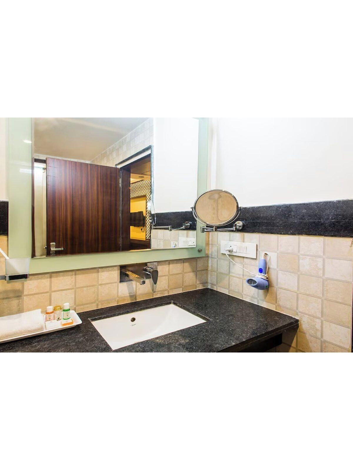A bathroom with a sink, mirror, and a towel rack.