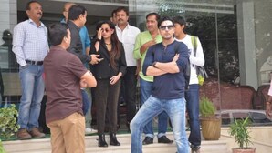 A group of people standing outside a building with a glass entrance. - Hotel The Westinn (Varanasi)