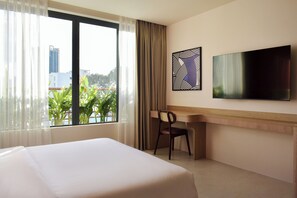 A hotel room with a bed, a desk, a chair, a TV, and a window with curtains. - Aizen Stay - District 1 (Ho Chi Minh City)