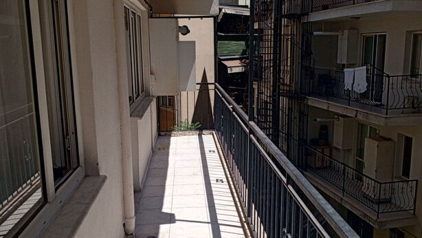 A narrow balcony with a tiled floor, a metal railing, and a view of adjacent buildings. - Anka 1 (Aydın)